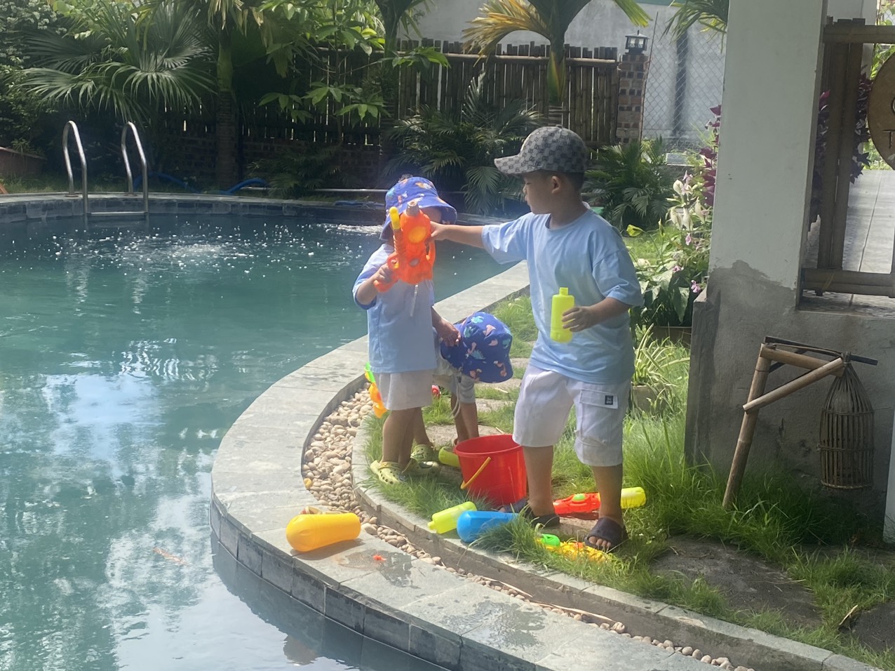Adorable children playing by the pool